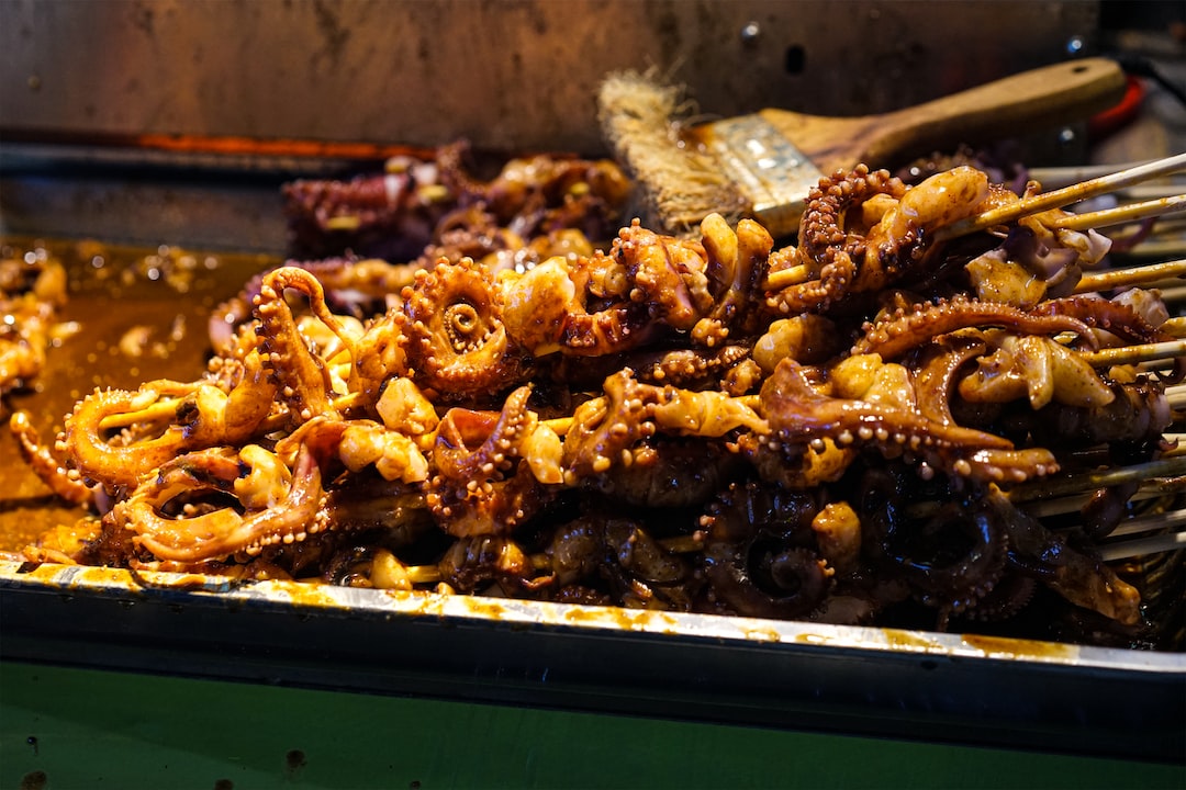 a pile of fried octopus sitting on top of a pan